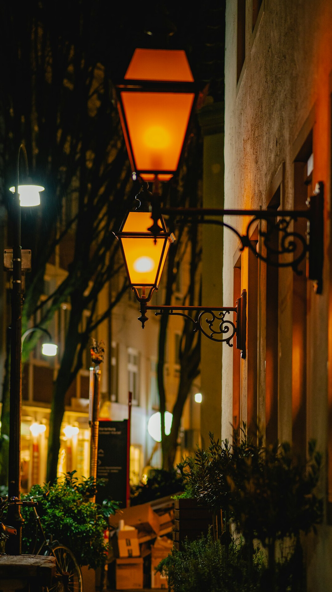Quiet old city street at dusk with warm lights