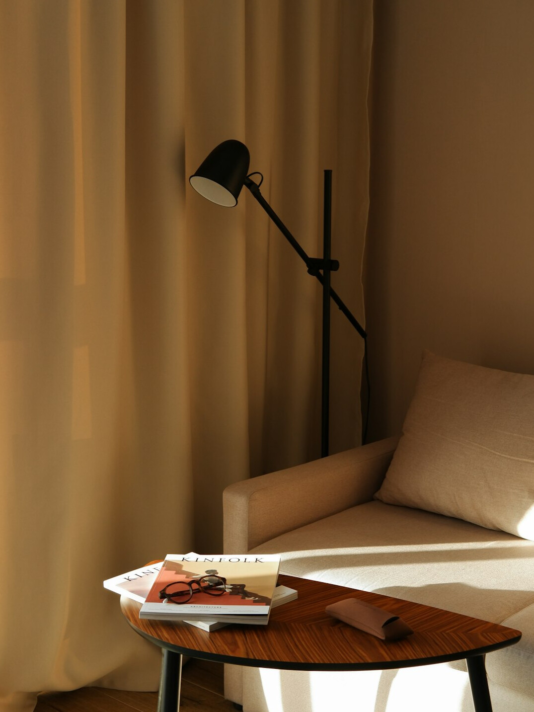 Open book on a table next to a reading lamp
